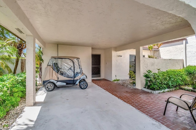 8030 Eastlake Dr Unit 10B, Boca Raton, FL 33433 - view of patio / terrace featuring a carport and fence