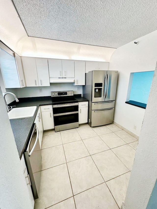 9235 SW 8th St Unit 402, Boca Raton, FL 33428 - kitchen with appliances with stainless steel finishes, a sink, under cabinet range hood, dark countertops, and a textured ceiling