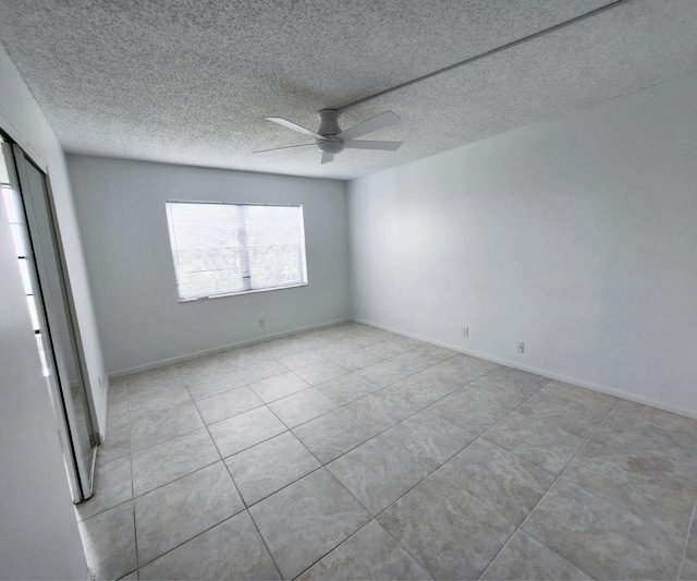 9235 SW 8th St Unit 402, Boca Raton, FL 33428 - unfurnished bedroom featuring tile patterned floors, a textured ceiling, and a ceiling fan