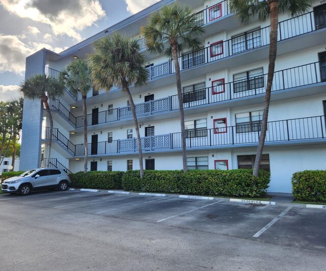9235 SW 8th St Unit 402, Boca Raton, FL 33428 - view of building exterior featuring uncovered parking