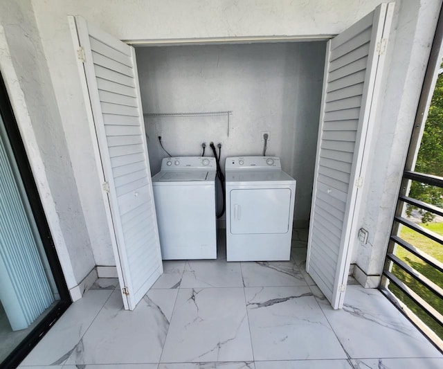 9235 SW 8th St Unit 402, Boca Raton, FL 33428 - laundry area with washer and dryer and marble finish flooring