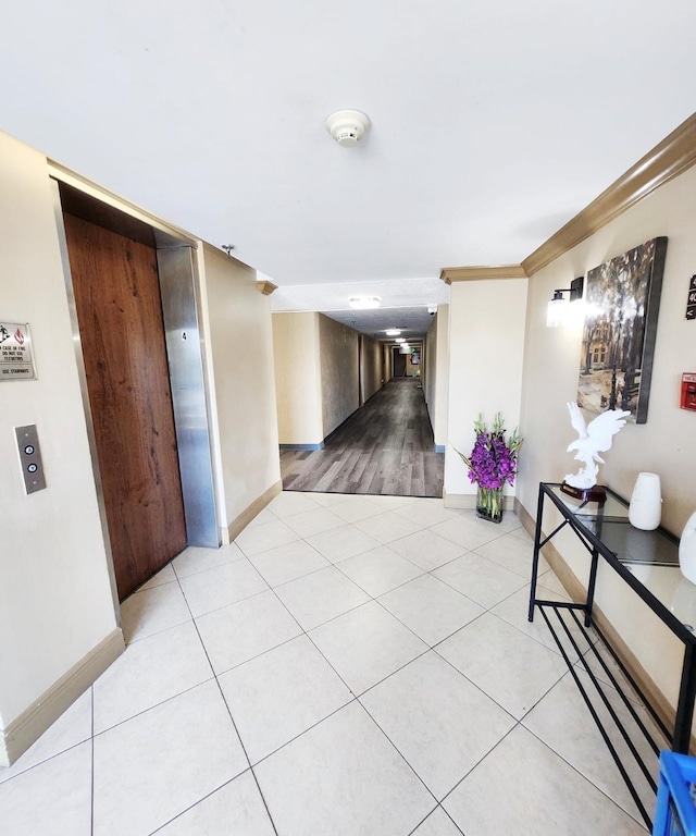 9235 SW 8th St Unit 402, Boca Raton, FL 33428 - hallway featuring baseboards, light tile patterned floors, and crown molding