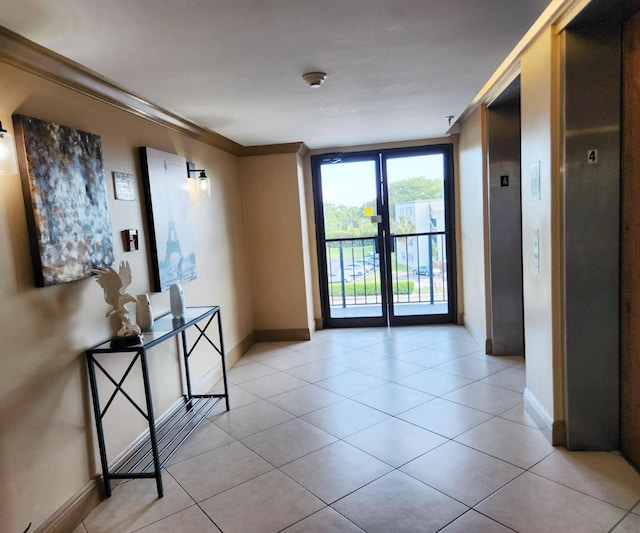 9235 SW 8th St Unit 402, Boca Raton, FL 33428 - hallway with elevator, crown molding, light tile patterned floors, baseboards, and french doors