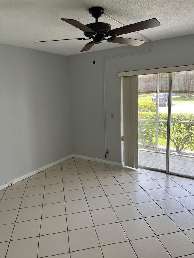 empty room featuring a ceiling fan, baseboards, and a textured ceiling