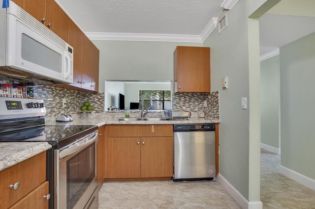 11500 NW 42nd St Unit 1-4, Coral Springs, FL 33065 - kitchen with stainless steel appliances, a sink, ornamental molding, tasteful backsplash, and baseboards
