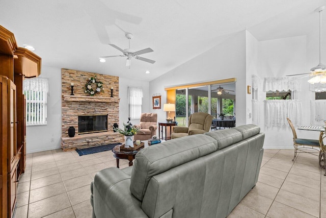 living room featuring ceiling fan, light tile patterned floors, lofted ceiling, a fireplace, and recessed lighting