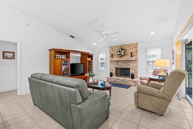 living room featuring plenty of natural light, lofted ceiling, a ceiling fan, light tile patterned flooring, and recessed lighting