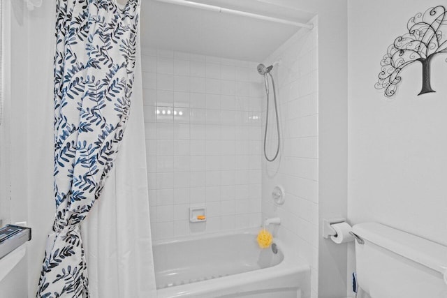 full bath with toilet and shower / bath combo with shower curtain