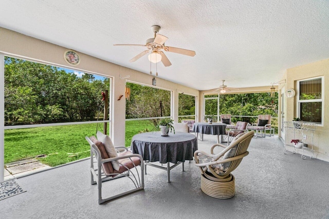 sunroom with ceiling fan and an outdoor hangout area