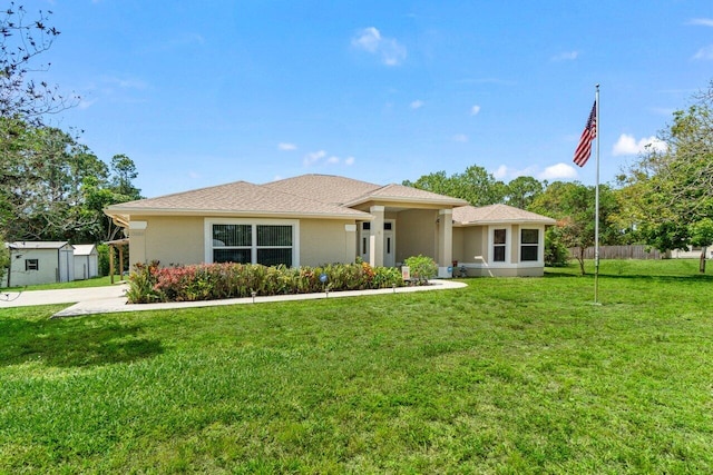 view of front of house featuring stucco siding and an outdoor structure