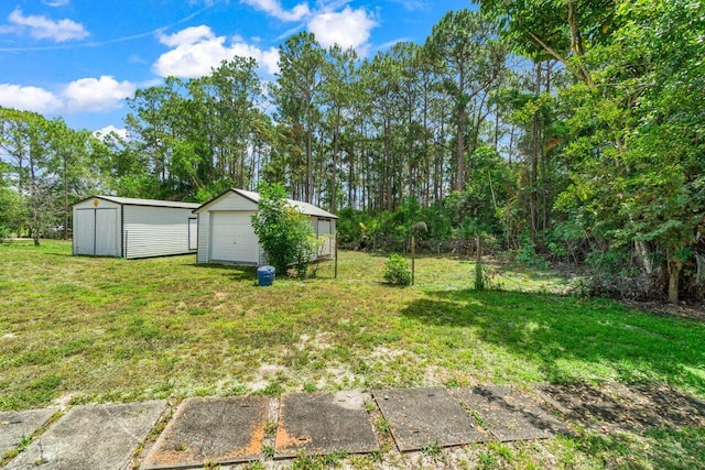 view of grassy yard with a detached garage, an outbuilding, and a storage shed