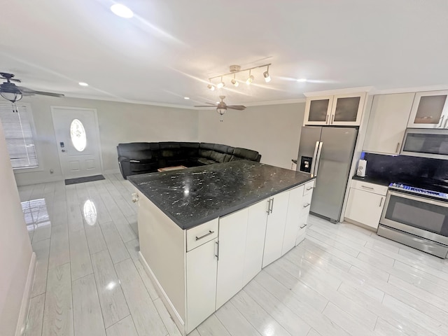 3946 A St, Palm Springs, FL 33461 - kitchen with stainless steel appliances, ceiling fan, a kitchen island, crown molding, and glass insert cabinets