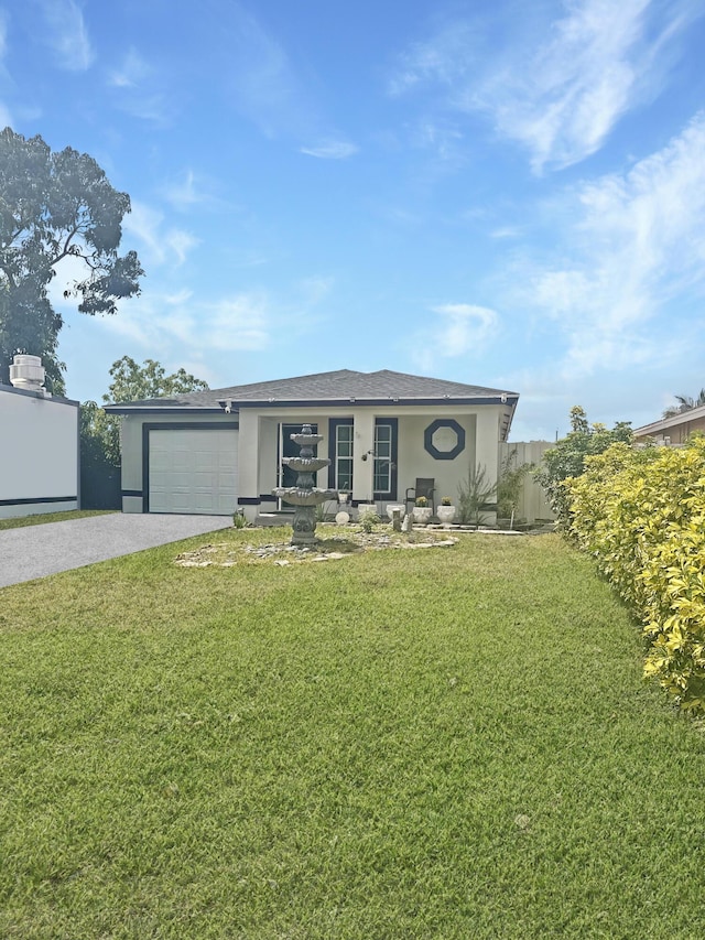 3946 A St, Palm Springs, FL 33461 - view of front of home featuring driveway, stucco siding, an attached garage, and a front yard