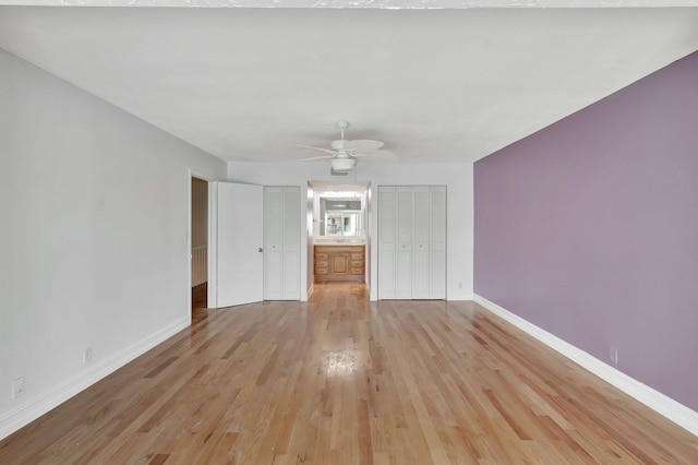 1100 Russell Dr, Highland Beach, FL 33487 - unfurnished living room featuring light wood-style flooring, baseboards, and ceiling fan