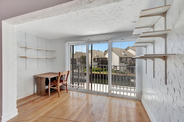 1100 Russell Dr, Highland Beach, FL 33487 - dining space featuring wood finished floors, baseboards, and a textured ceiling