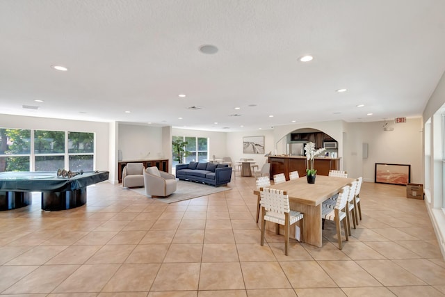 1100 Russell Dr, Highland Beach, FL 33487 - dining space featuring light tile patterned floors, recessed lighting, and arched walkways