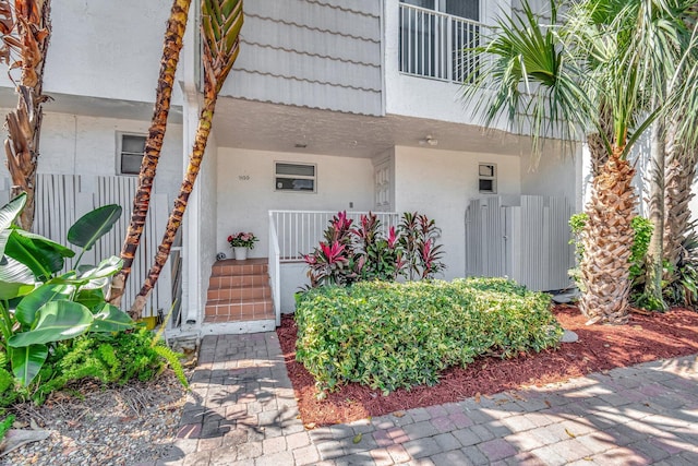 1100 Russell Dr, Highland Beach, FL 33487 - doorway to property with stucco siding and covered porch