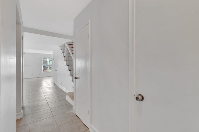 1100 Russell Dr, Highland Beach, FL 33487 - corridor featuring stairway, light tile patterned floors, and baseboards