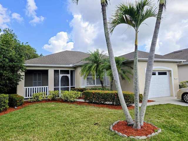 view of front of house featuring a front yard, stucco siding, an attached garage, and driveway
