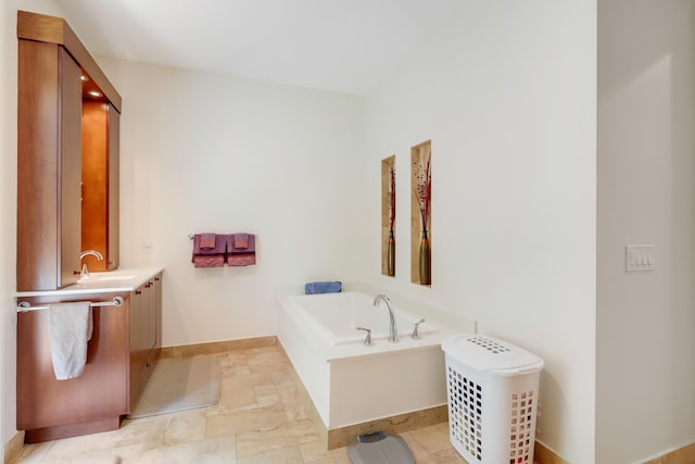 391 Glenbrook Dr, Atlantis, FL 33462 - bathroom featuring vanity, a garden tub, and baseboards