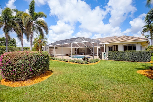 391 Glenbrook Dr, Atlantis, FL 33462 - rear view of house featuring a yard, a lanai, stucco siding, a chimney, and an outdoor pool