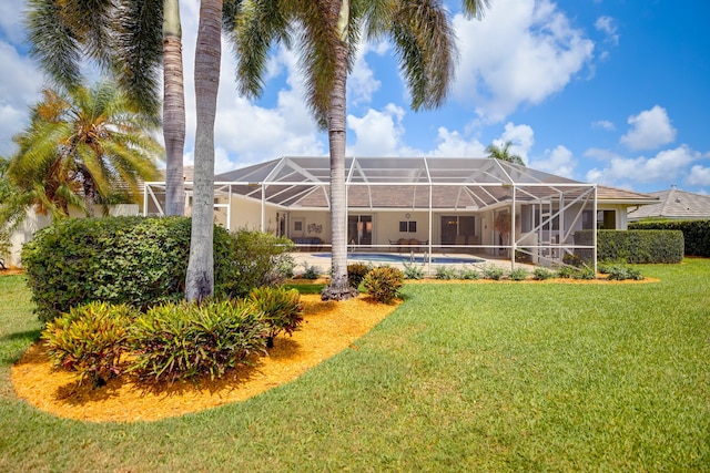 391 Glenbrook Dr, Atlantis, FL 33462 - rear view of house featuring a lawn and glass enclosure