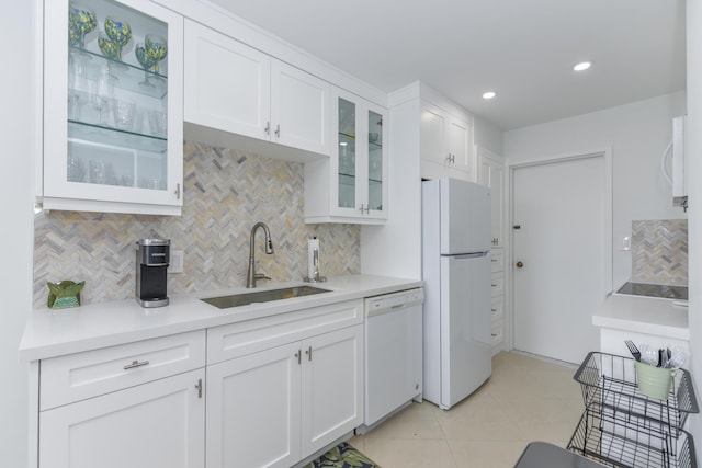 2860 S Ocean Blvd Unit 202, Palm Beach, FL 33480 - kitchen featuring white appliances, a sink, backsplash, white cabinetry, and light countertops