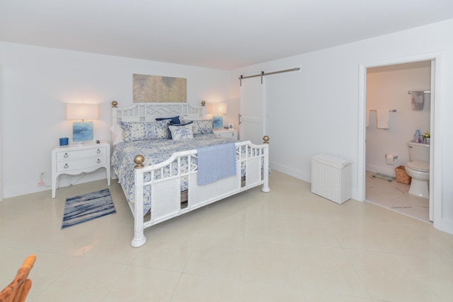 2860 S Ocean Blvd Unit 202, Palm Beach, FL 33480 - bedroom with a barn door, tile patterned floors, ensuite bathroom, and baseboards