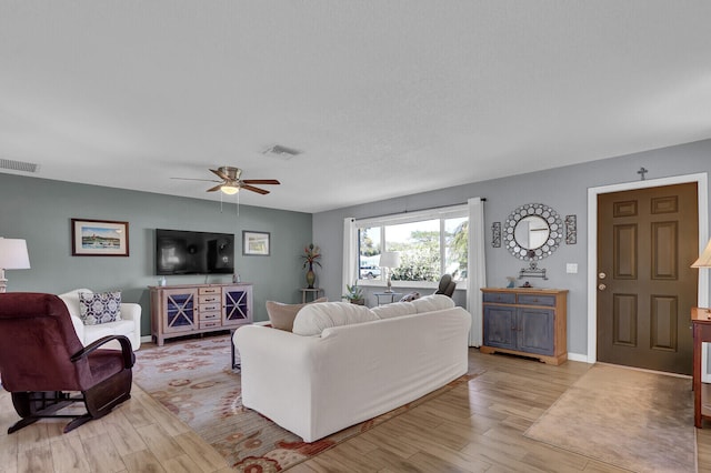 living room featuring light wood finished floors and ceiling fan