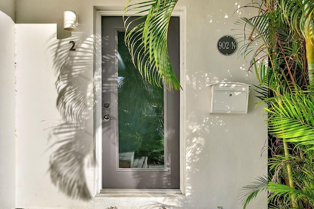 doorway to property with stucco siding