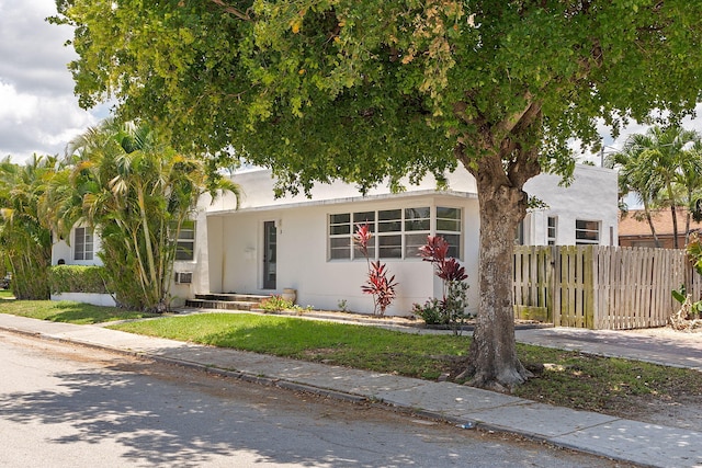 view of front of home featuring fence