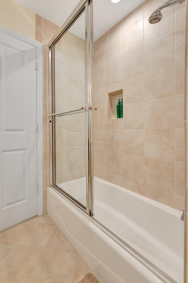 bathroom with tile patterned floors and combined bath / shower with glass door