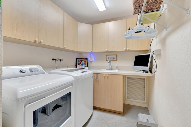 clothes washing area featuring cabinet space, separate washer and dryer, and light tile patterned floors
