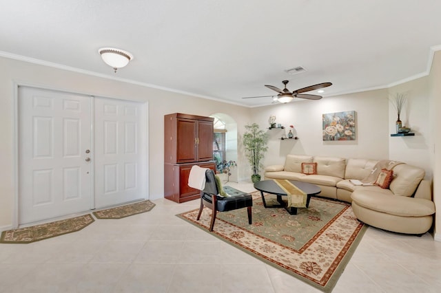 living room featuring ornamental molding, light tile patterned floors, and a ceiling fan