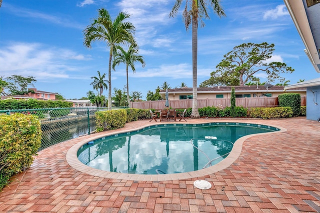 view of swimming pool with a patio and a fenced backyard