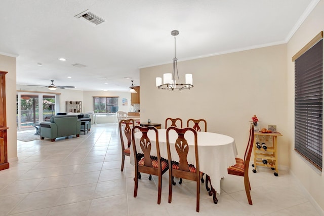 dining space featuring a chandelier, crown molding, recessed lighting, light tile patterned flooring, and a ceiling fan