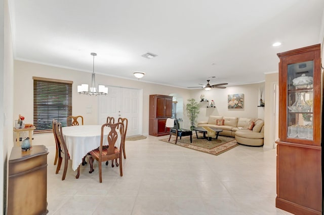dining room with ornamental molding, a chandelier, a ceiling fan, and light tile patterned flooring