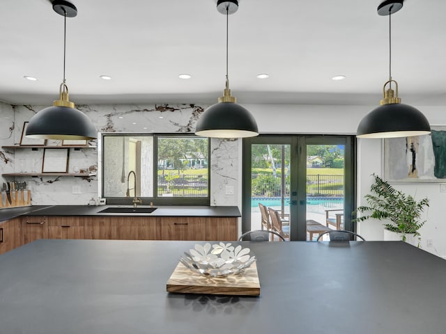 2708 NW 26th Cir, Boca Raton, FL 33431 - kitchen featuring a sink, brown cabinets, plenty of natural light, and recessed lighting
