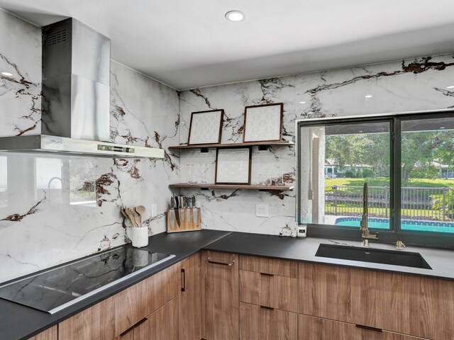 2708 NW 26th Cir, Boca Raton, FL 33431 - kitchen featuring wall chimney range hood, open shelves, black electric cooktop, a sink, and decorative backsplash