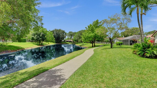 2708 NW 26th Cir, Boca Raton, FL 33431 - surrounding community with a water view and a lawn