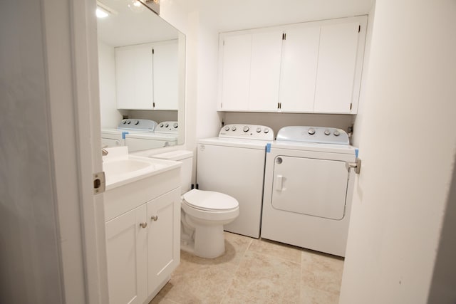 washroom with washing machine and dryer, laundry area, and light tile patterned floors