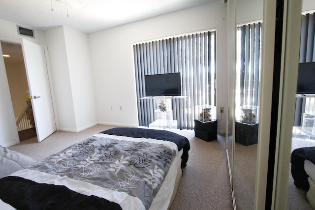 bedroom featuring baseboards, carpet flooring, and visible vents