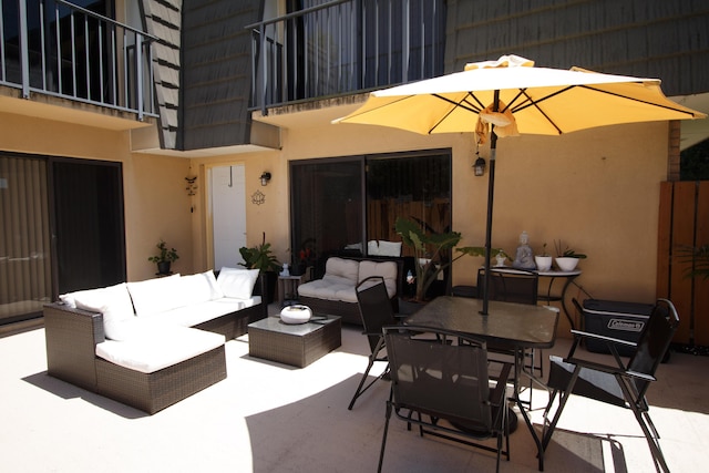view of patio featuring an outdoor living space and a balcony