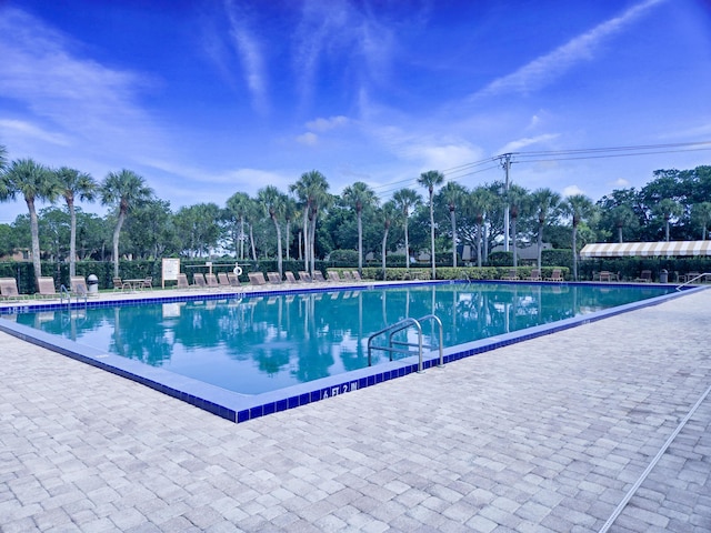 community pool with a patio area