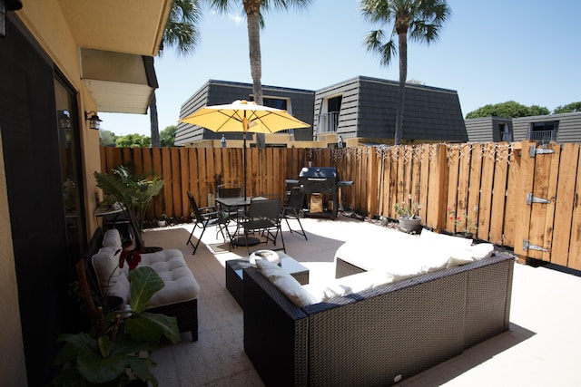 view of patio / terrace featuring outdoor dining area, a grill, fence, and an outdoor living space