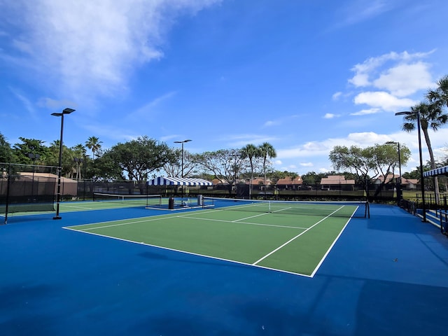 view of sport court featuring fence
