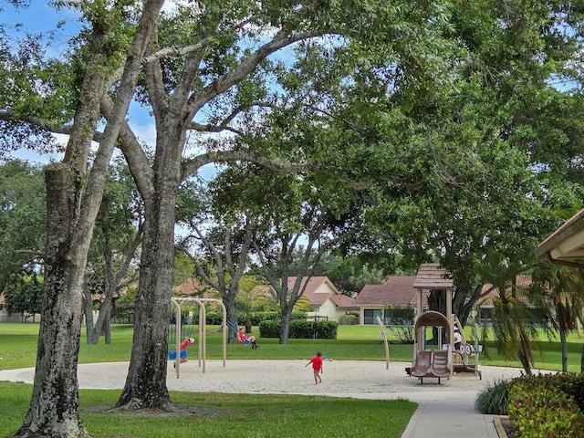 view of property's community featuring a yard and playground community