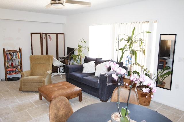 living room featuring a healthy amount of sunlight and ceiling fan