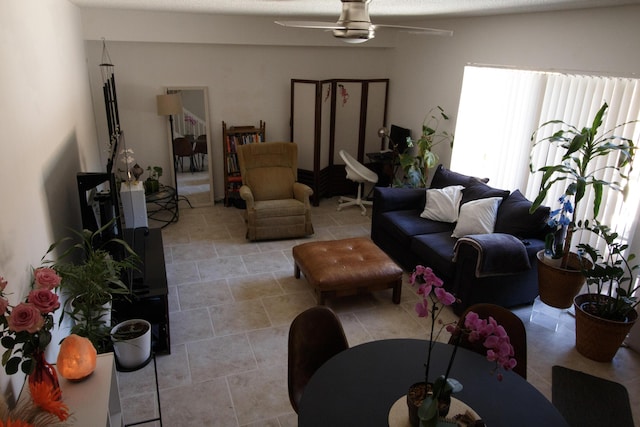 living room with light tile patterned flooring and a ceiling fan