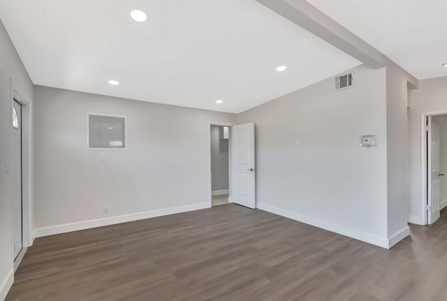 empty room with baseboards, dark wood finished floors, and recessed lighting
